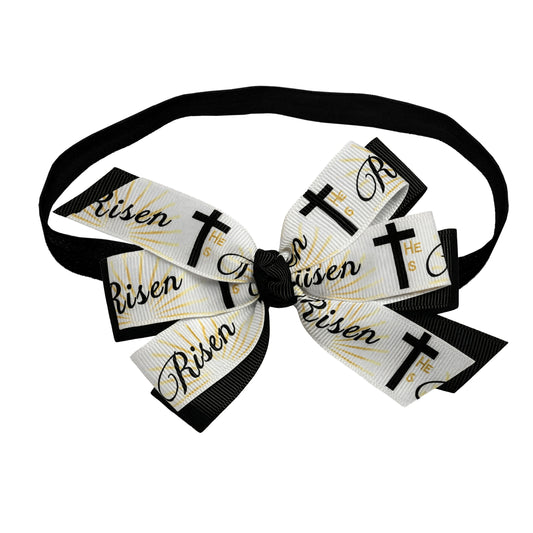 Bow tie with 'Risen' and cross designs on a white background