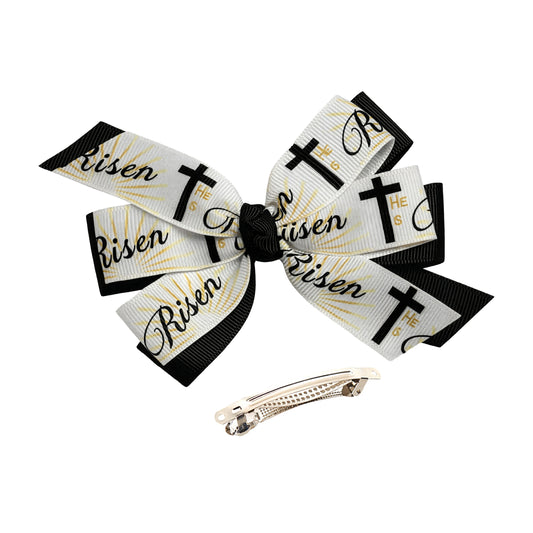 Hair bow with 'He is Risen' text and crosses, accompanied by a hair clip on a white background.