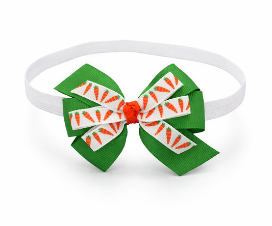 Green bow with carrot pattern on a white headband